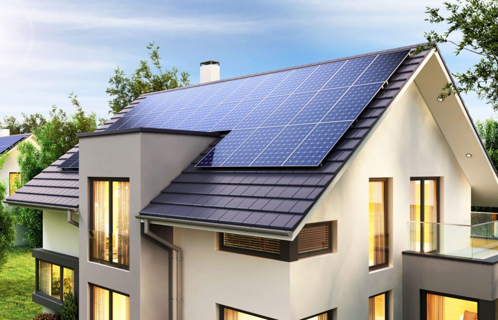 A beautiful home with solar panels on the dark tile roof.